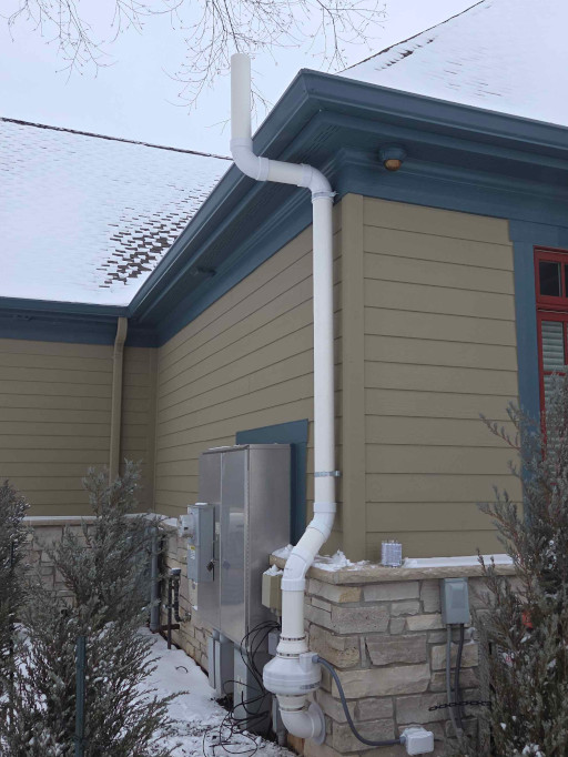 Typical exterior or outside radon vent piping with fan. Radon Safe Homes and Businesses