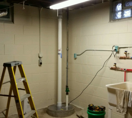 Radon system with suction point in sealed sump pit. Radon Safe Homes and Businesses